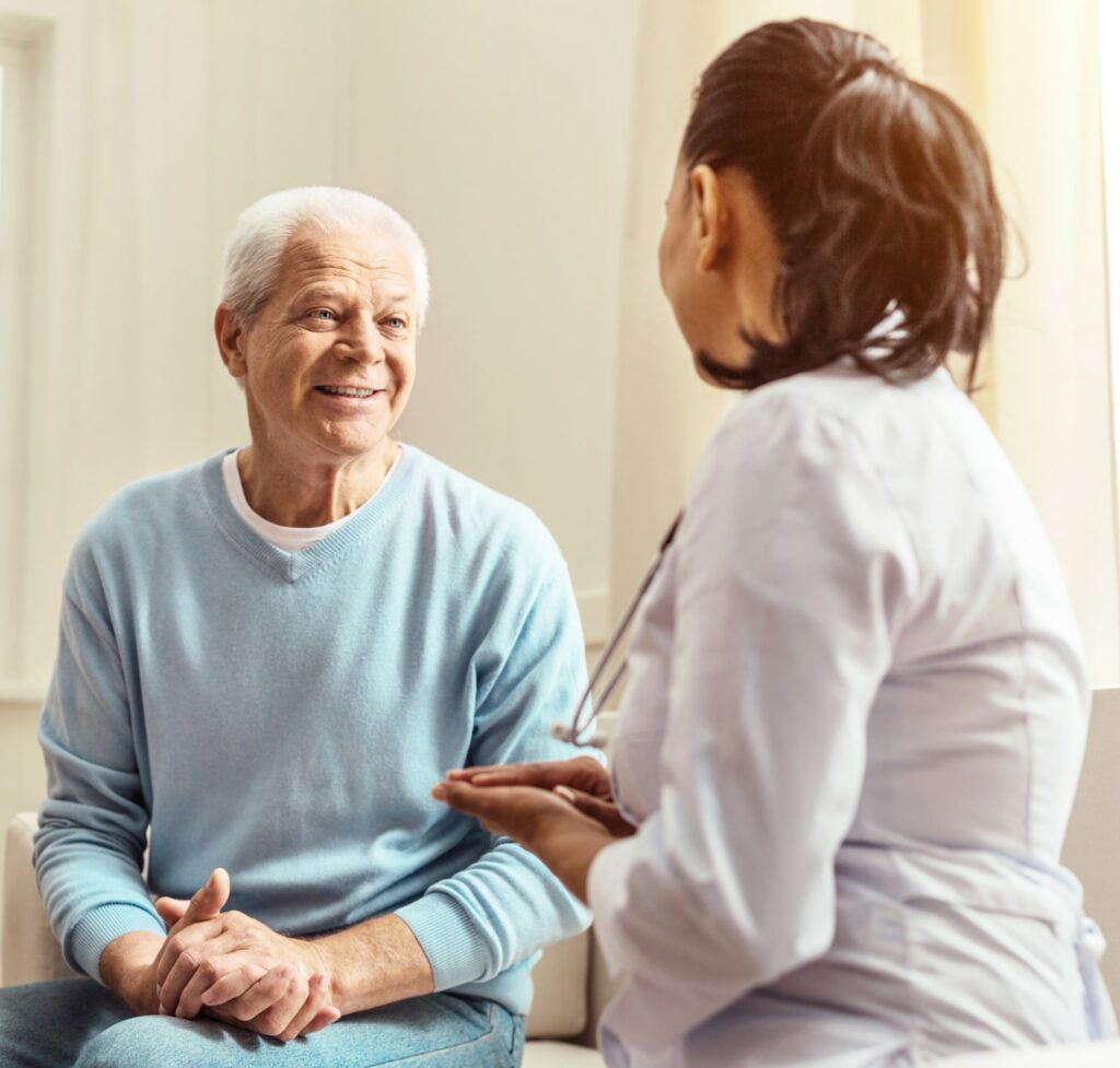 Pleasant elderly man having a conversation with doctor
